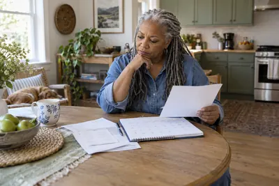 A person checking a bill and payment calendar