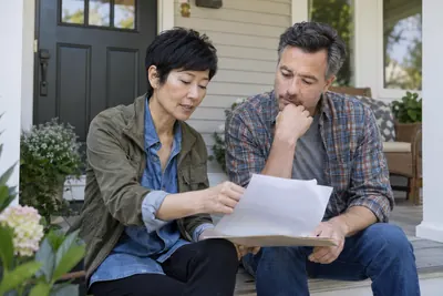 People reviewing home and mortgage paperwork